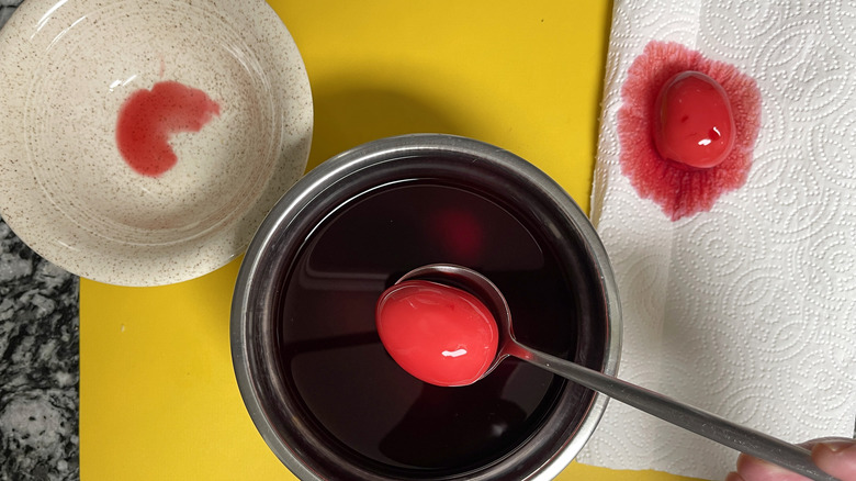 pink-dyed egg in spoon