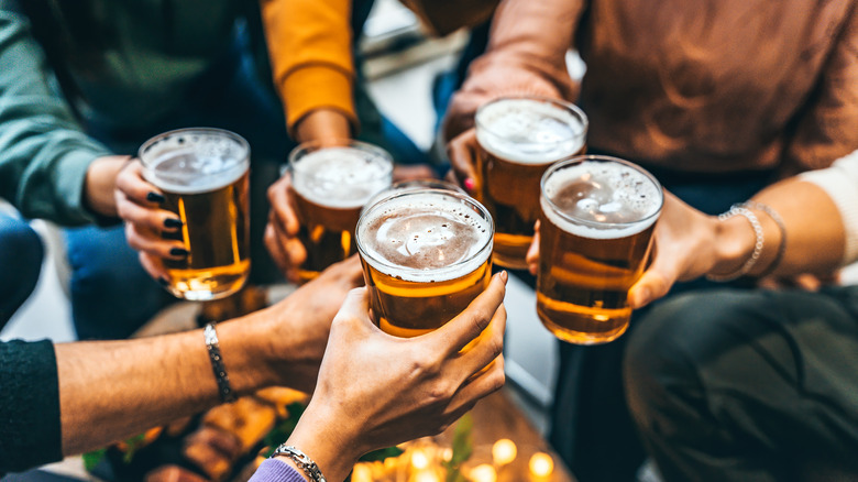 Hands toasting with beers