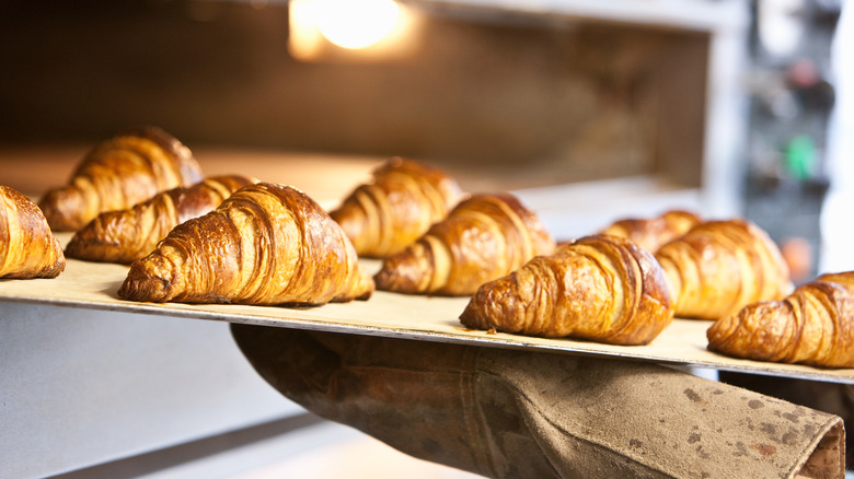 removing baked croissants from oven