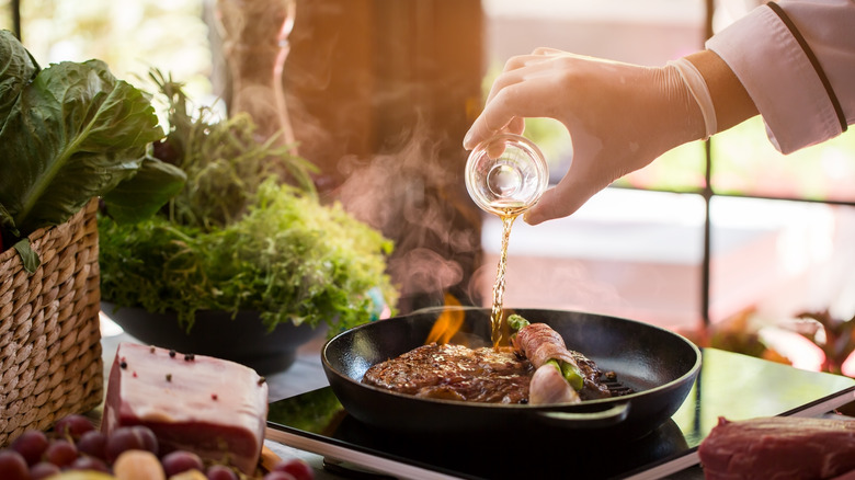 alcohol being poured into pan