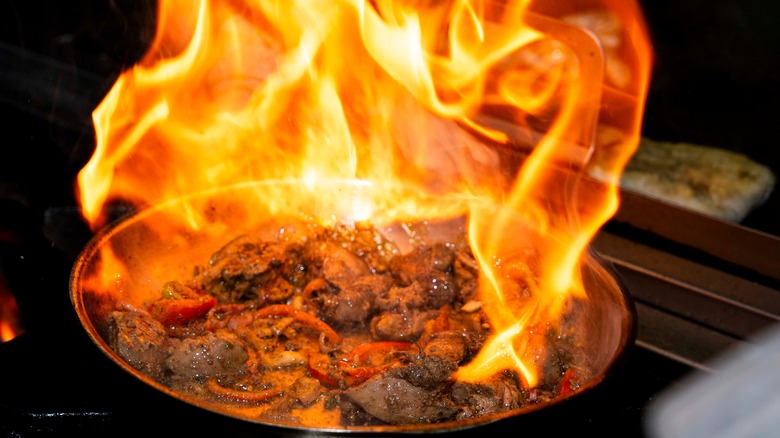 meat flambéing in pan