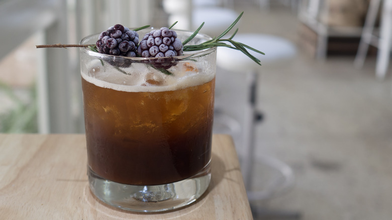 cold coffee garnished with blackberries 