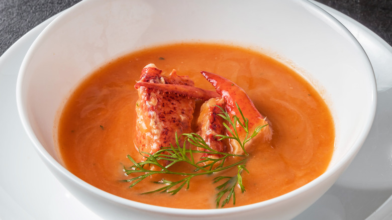 bowl of lobster pumpkin soup with herbs