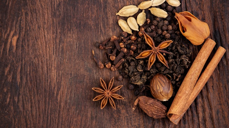 Masala chai spices against a wooden background