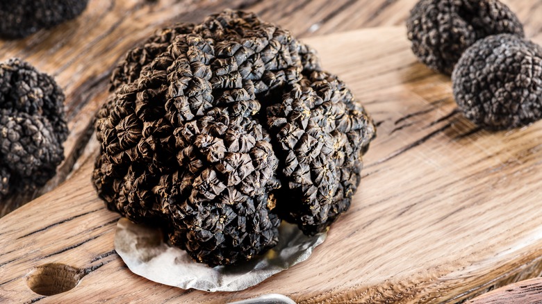 black truffles on a wooden cutting board