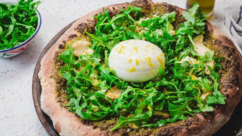 Pizza with big burrata bowl and arugula on the side