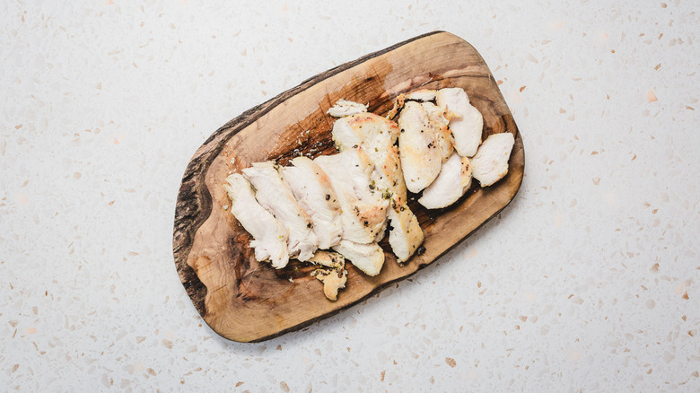 Sliced chicken on board