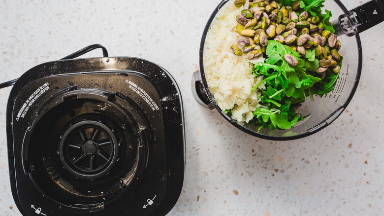 Pistachio pesto ingredients in processor bowl