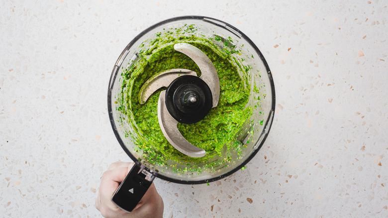 Bright green pesto in processor bowl