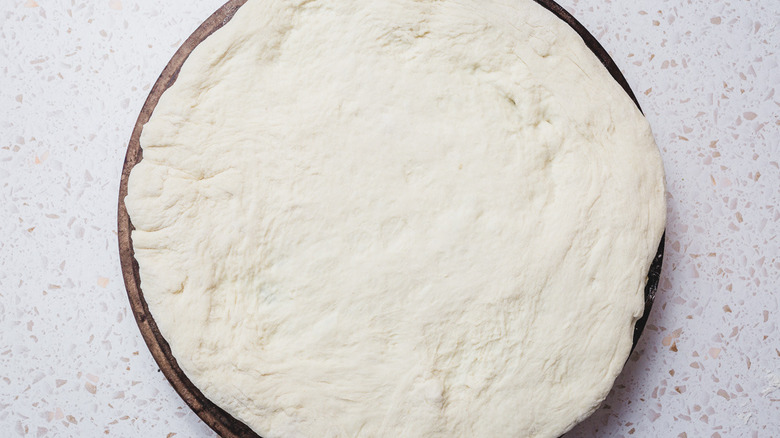 Pizza dough on pizza stone