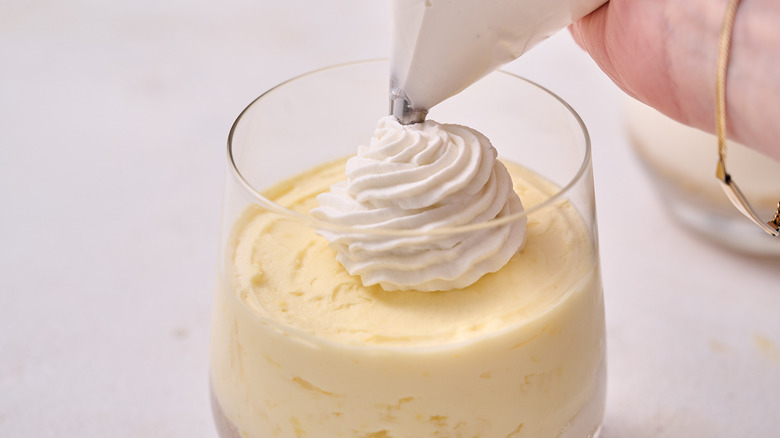 piping whipped cream onto coconut lush