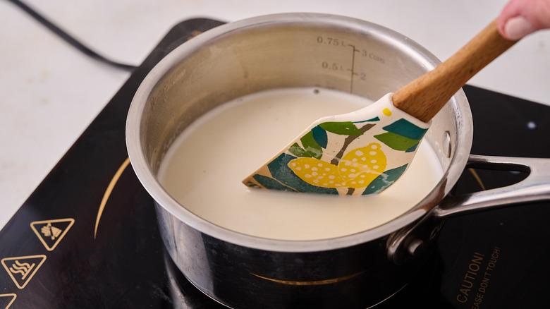 stirring cream in saucepan