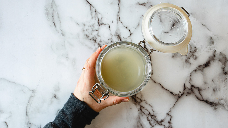 hand holding a jar 