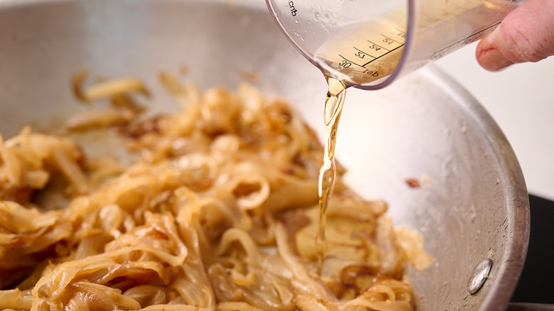 pouring brandy into skillet