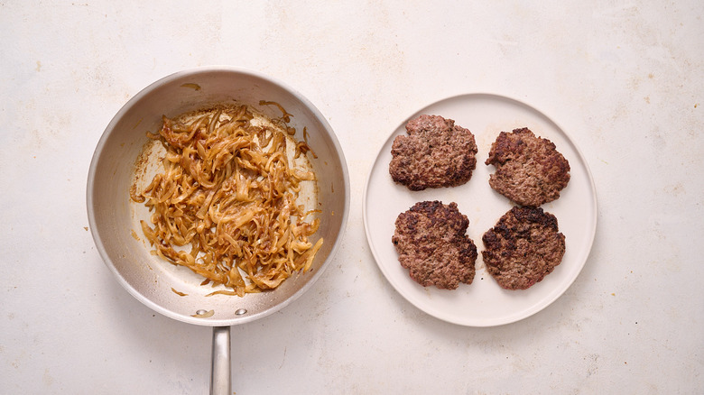 burgers and onions on table