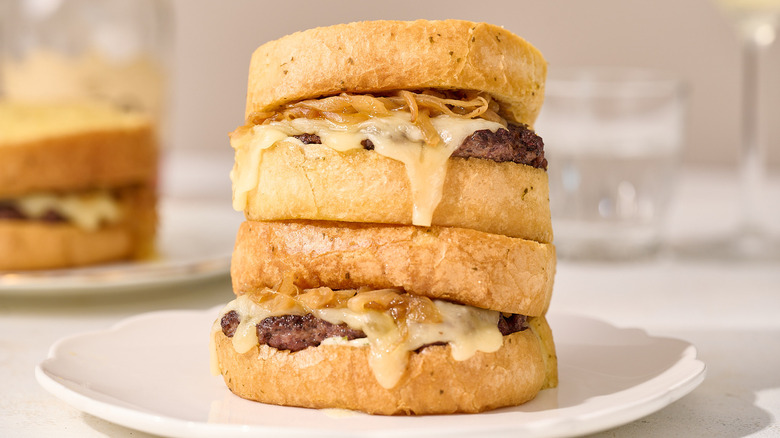 patty melts stacked on plate