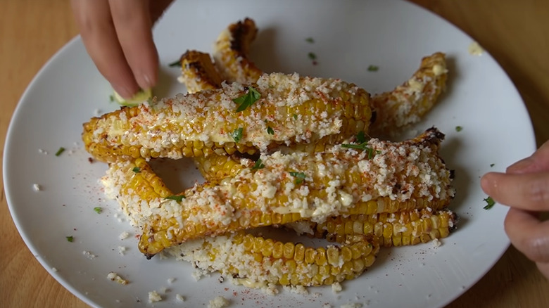 Elotes corn ribs on white plate