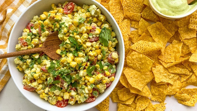 corn dip in bowl with bowl of chips