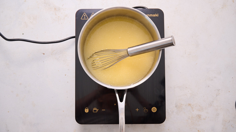 whisking cornmeal in pot