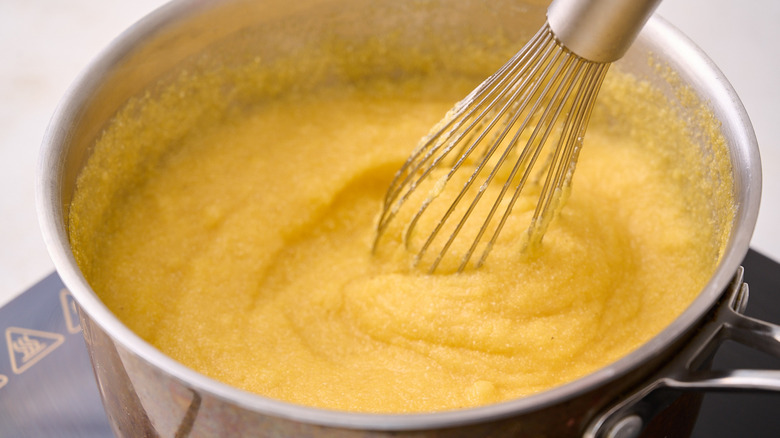 whisking polenta in pot