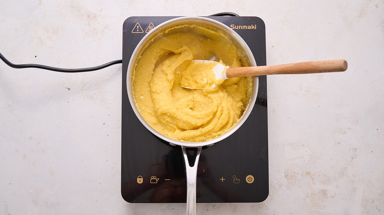 stirring polenta in pot