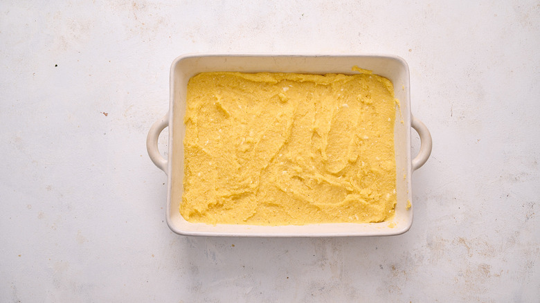 spreading polenta in dish