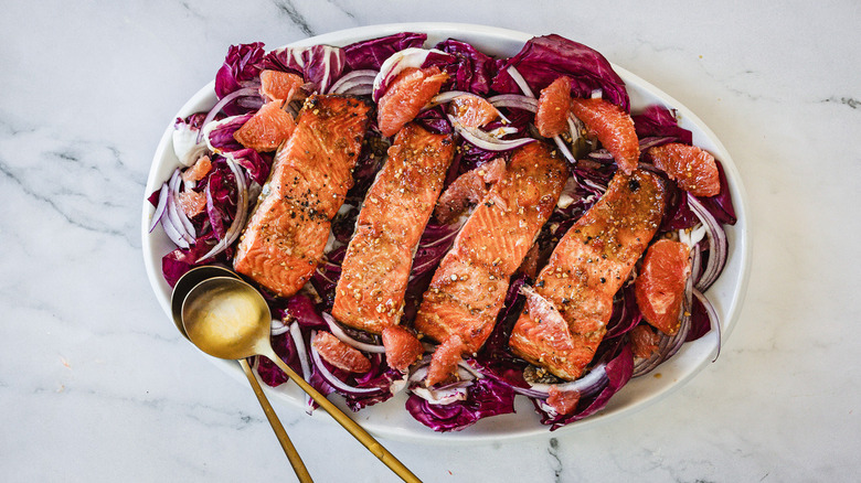 Salmon grapefruit salad with golden spoons