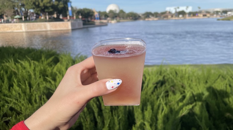 Fizzy pink drink in square cup