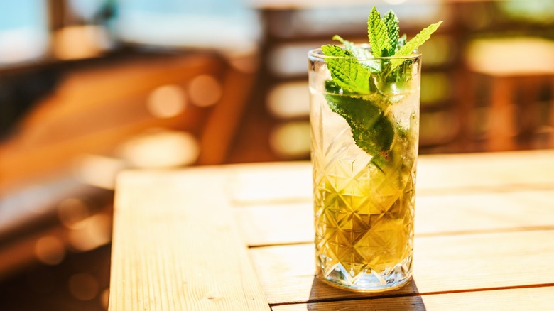 A mint cocktail on a wooden table