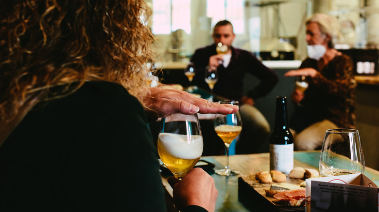 People taste testing beer glasses 