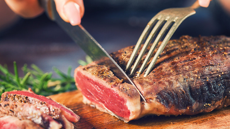 Person cutting a steak