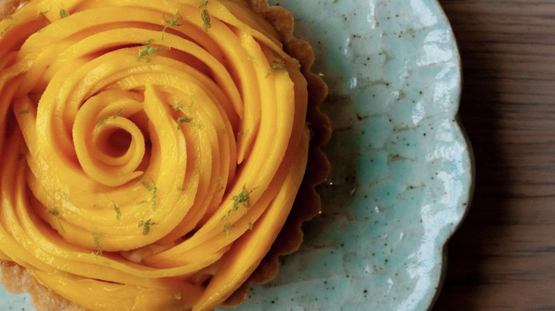 Mango tart on blue plate