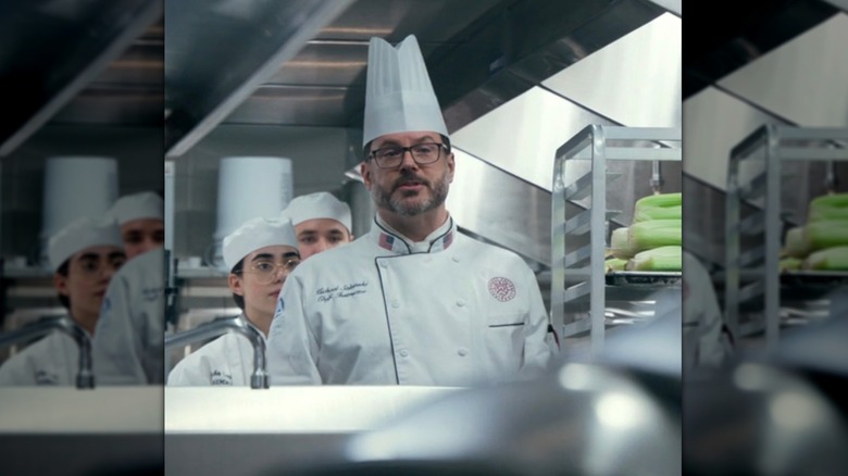 Chef and students in restaurant kitchen