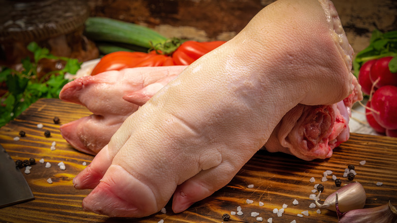 pig trotters on wooden board with seasonings