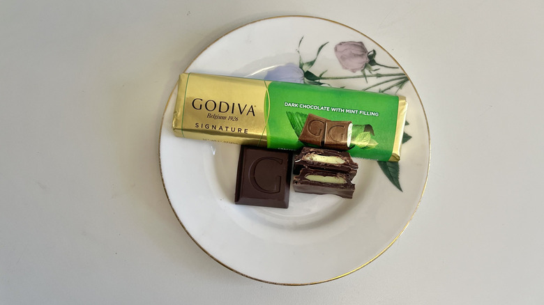 A Godiva mint bar is displayed on a plate.