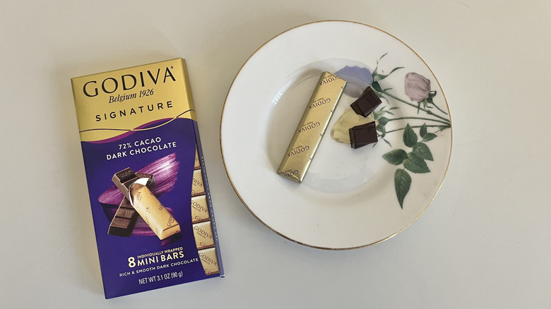 A Godiva 72% dark chocolate bar is shown on a plate next to the packaging.