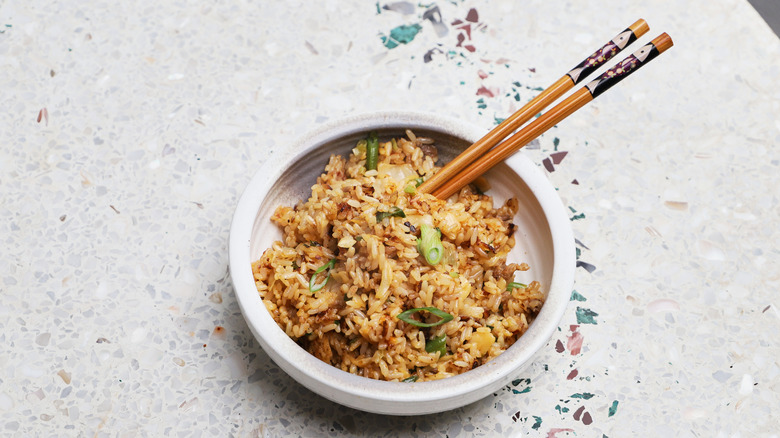 Bowl of fried rice with chopsticks 