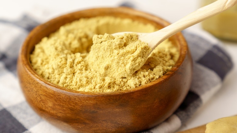 Mustard powder in a wooden bowl