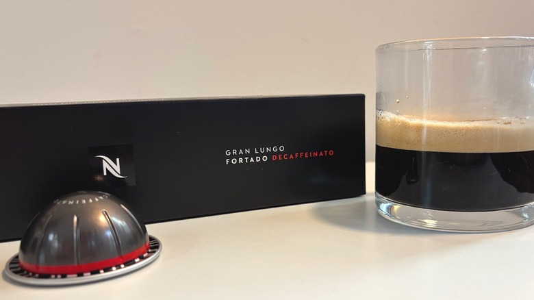 Clear mug with Nespresso Gran Lungo Fortado Decaffeinato next to box and pod on white table