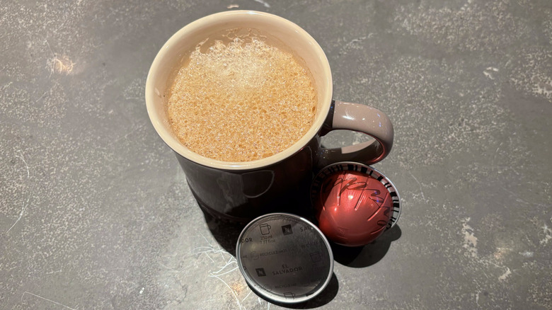 Coffee cup with red Nespresso El Salvador pods