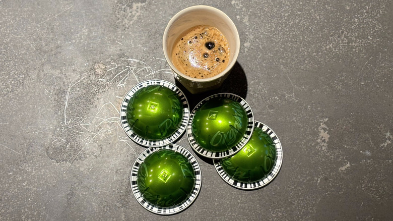 Espresso cup with green Nespresso Peru pods