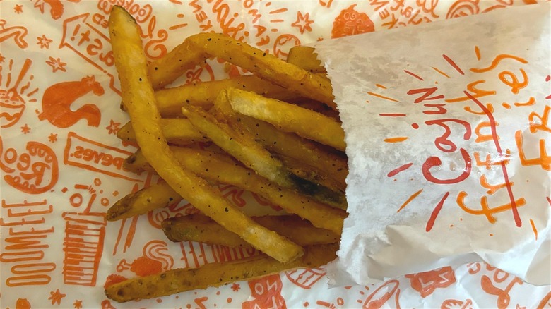 Overhead shot of Popeyes cajun fries on Popeyes wrapper