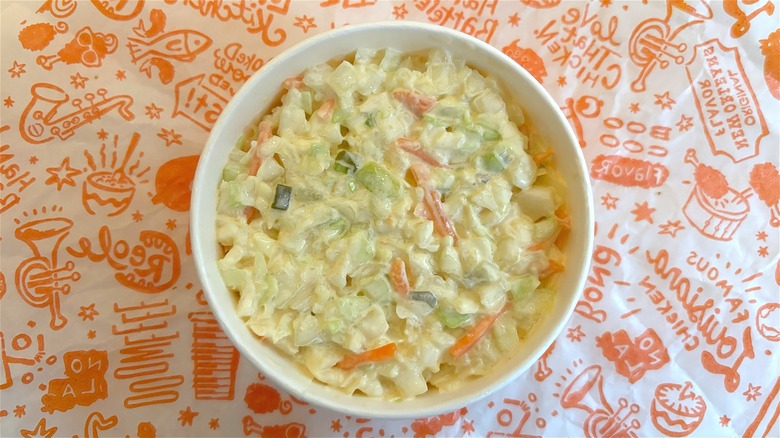 Overhead shot of Popeyes coleslaw on Popeyes wrapper