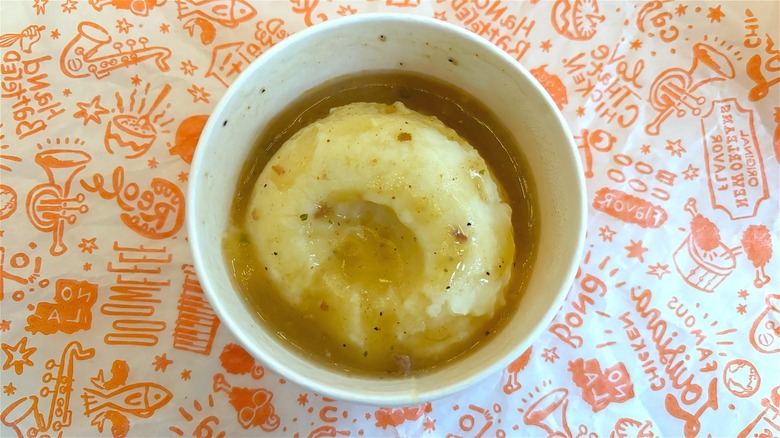 Overhead shot of Popeye's mashed potatoes and gravy on Popeyes wrapper