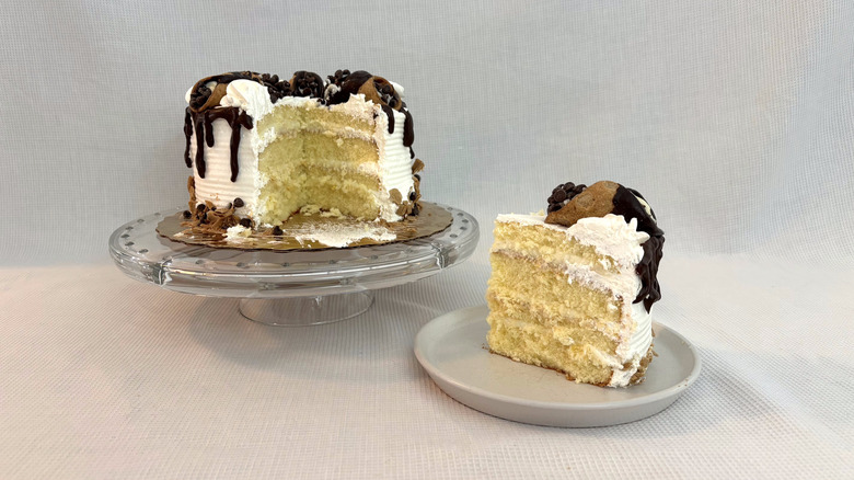 Publix Orange Cannoli Supreme Cake on glass cake stand and slice on white plate