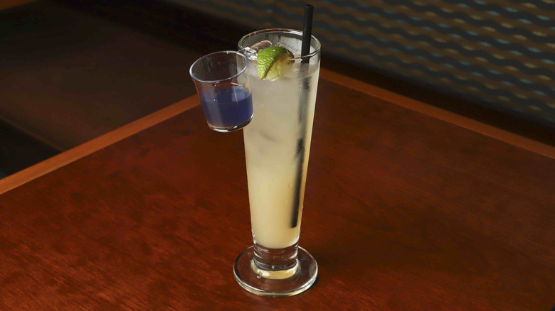 Tall glass with an attached sidecar