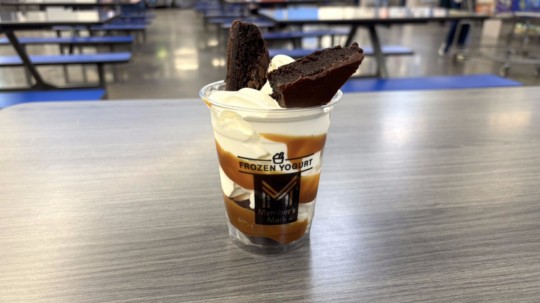 Sam's Club brownie sundae in plastic cup on table in food court