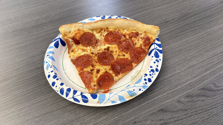 Sam's Club pepperoni pizza slice on paper plate on table