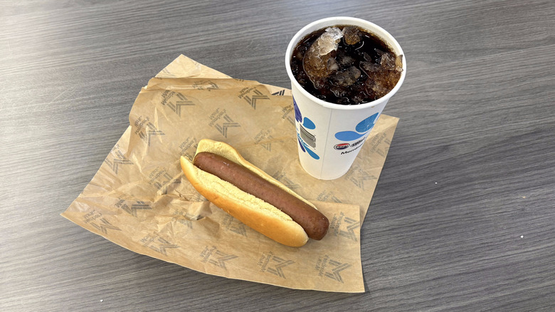Sam's Club quarter-pound hot dog combo with soda on paper wrapper on table