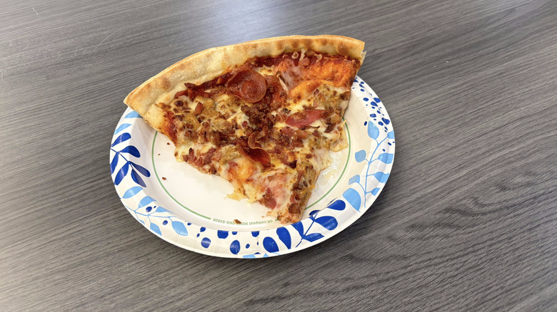 Sam's Club 4-meat pizza slice on paper plate on table